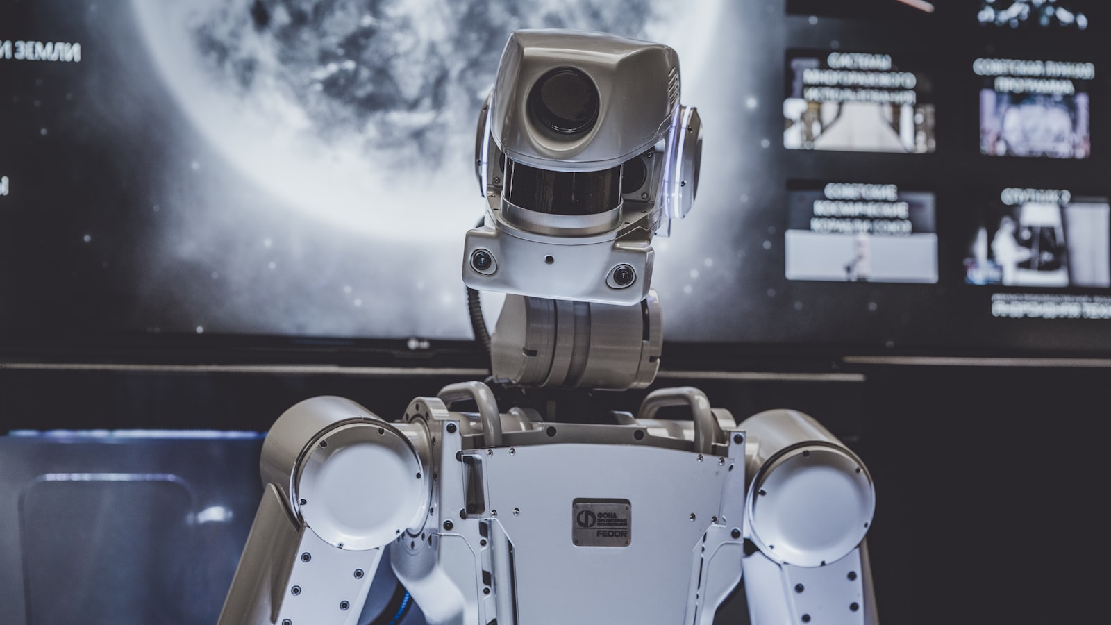 The useful picture of AI at work is not a glowing brain. It is a machine that still needs a person standing next to it.